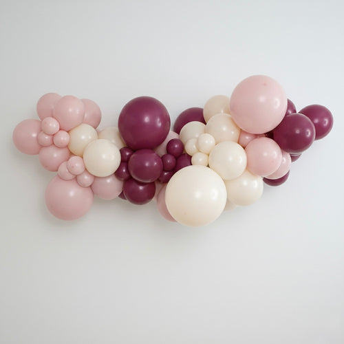DIY balloon garland kit in our Joiène Original colours featuring a mix of blush pink, muted sand and wild berry coloured latex balloons styled in a professional organic garland.